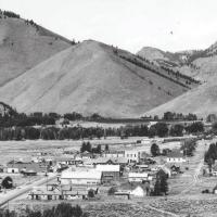 Aerial view of historic Ketchum, Idaho 1930's black and white photo showing a rural town with mountains rising in the background