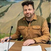 Photo of Spencer In a City Council Meeting