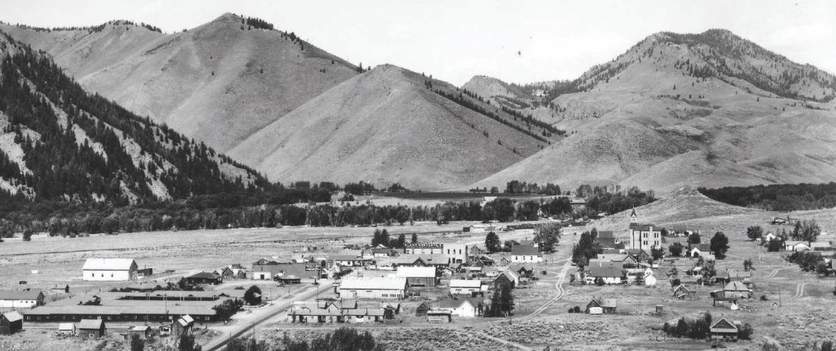 Aerial view of historic Ketchum, Idaho 1930's black and white photo showing a rural town with mountains rising in the background