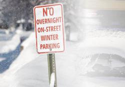 Photo of sign stating "NO OVERNIGHT ON-STREET WINTER PARKING"